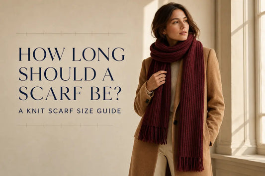 Woman wearing a long burgundy knit scarf for a scarf length and width size guide