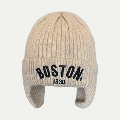 beige earflap beanie with rib knit texture and front logo