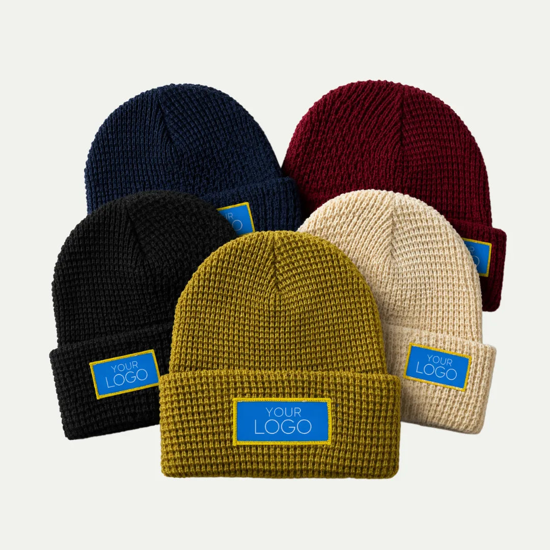 assorted waffle texture cuffed beanies in multiple colors with front logo patch
