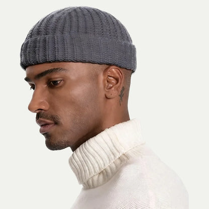 man wearing gray short fisherman ribbed beanie with folded cuff