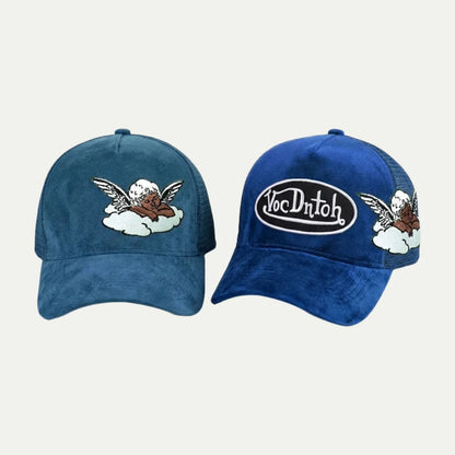 two blue custom suede mesh trucker hats with embroidered front and side patches