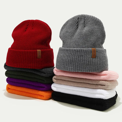 ribbed knit cuffed beanies stacked in multiple colors with folded cuffs