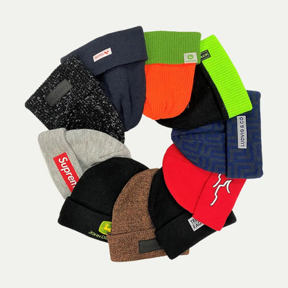 stacked cuffed knit beanies in multiple colors with visible labels