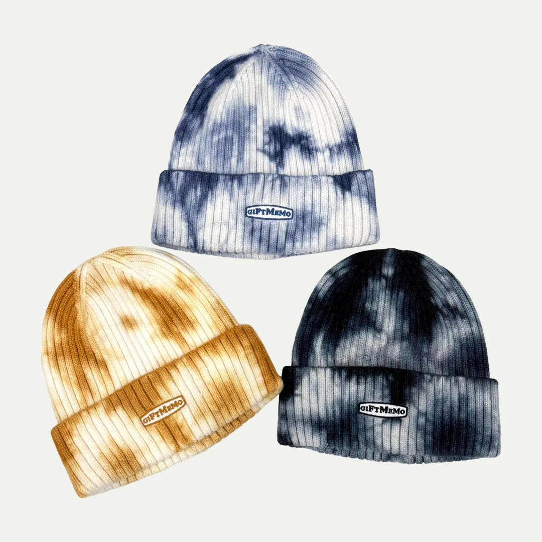 tie-dye cuffed beanies in blue, brown, and black tones displayed together