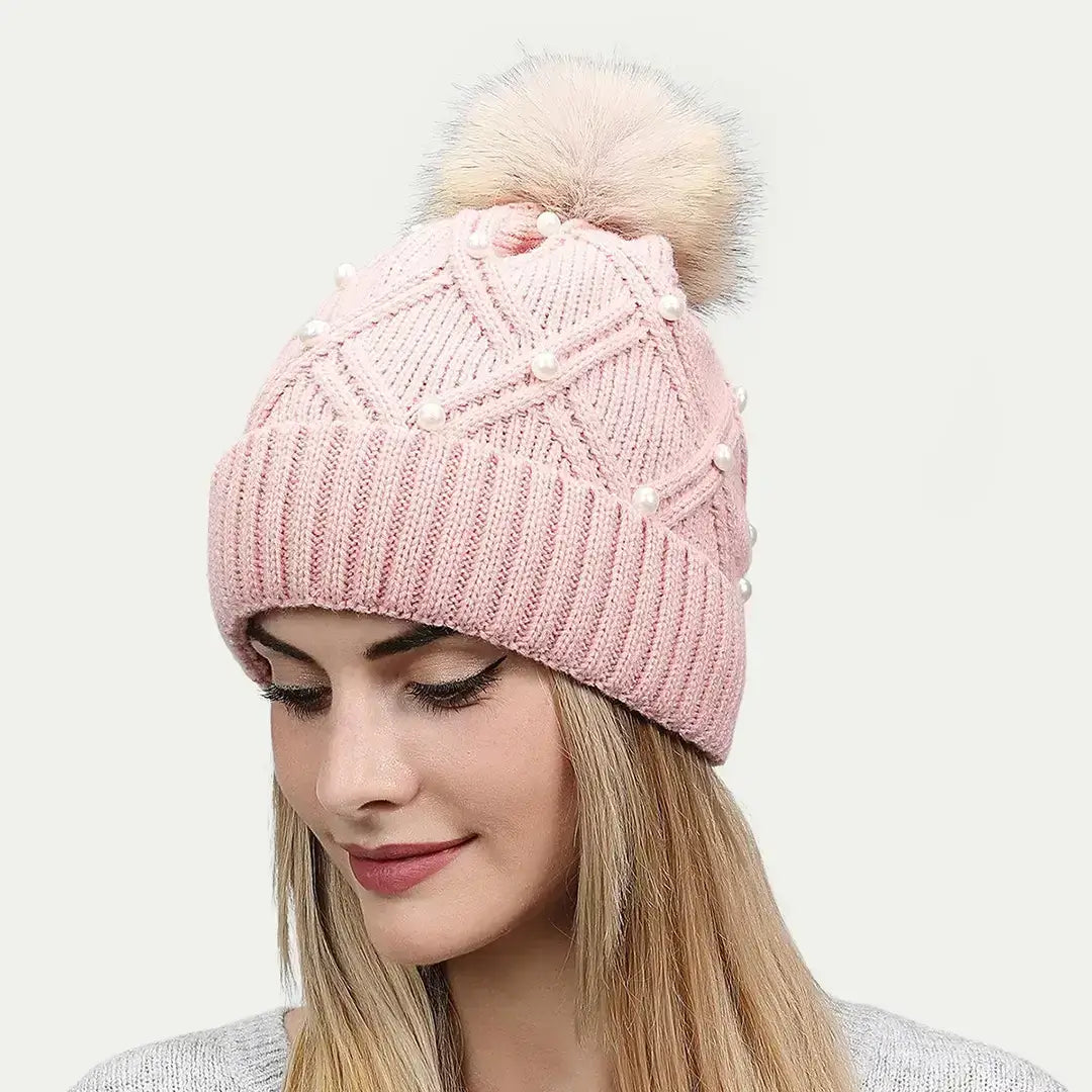 woman wearing pink pearl pom beanie